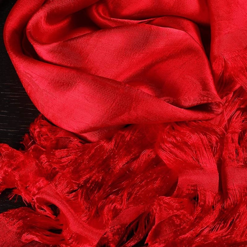 Red tibetan khata scarf close-up showing rich scarlet color, soft fabric drape, and hand-finished tassels