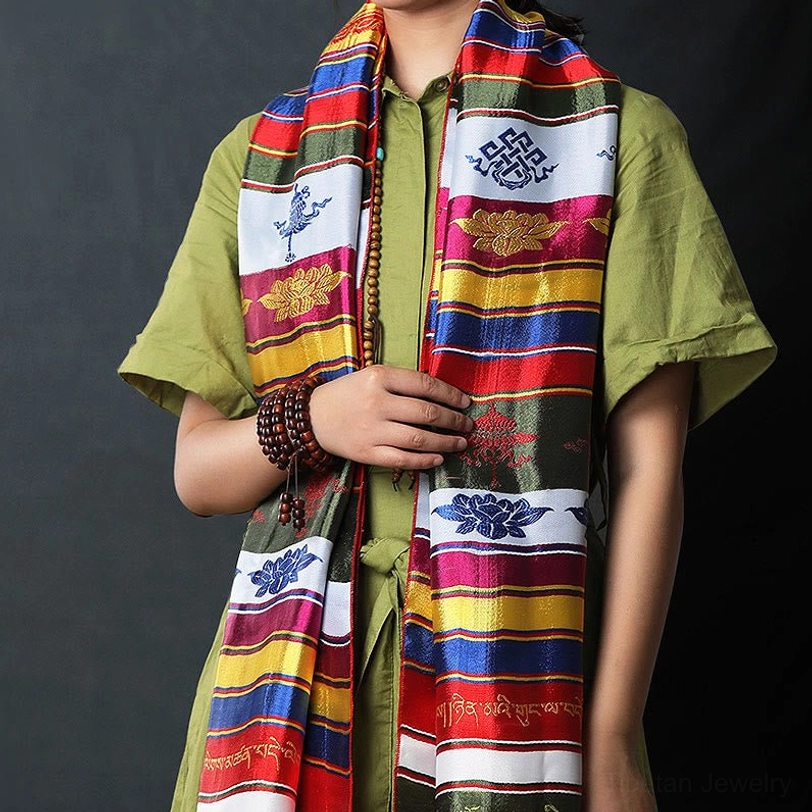 Tibetan multicolored lotus khata scarf styled on model wearing green shirt with prayer beads and detailed embroidery visible