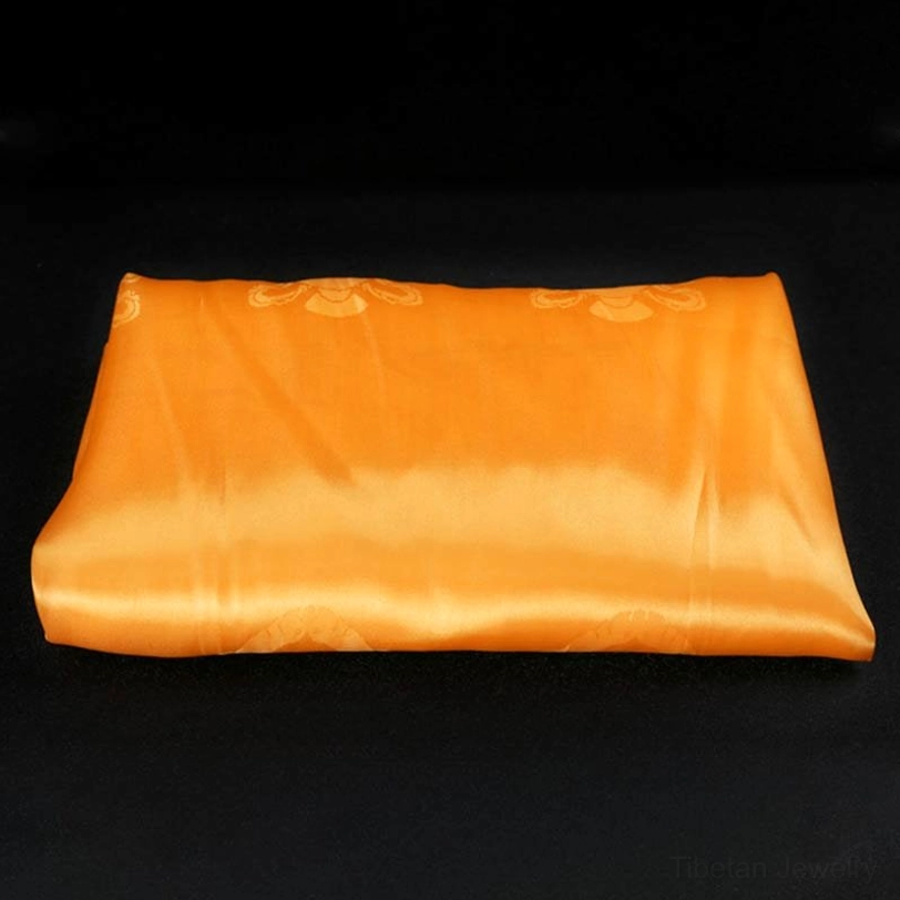 Single yellow Tibetan khata with wisdom-infused satin texture and embossed auspicious decorative patterns