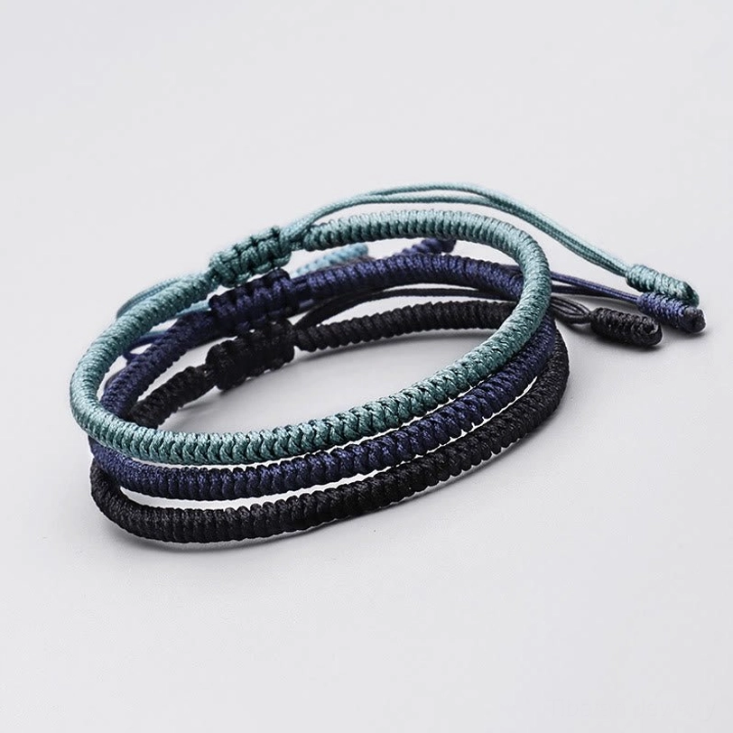 Three King Kong knot protection bracelets in vibrant colors - handcrafted Tibetan Buddhist amulet set stacked display