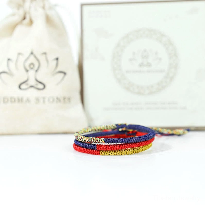 Tibetan braided faith bracelet displayed with Buddha Stones branded gift pouch and packaging