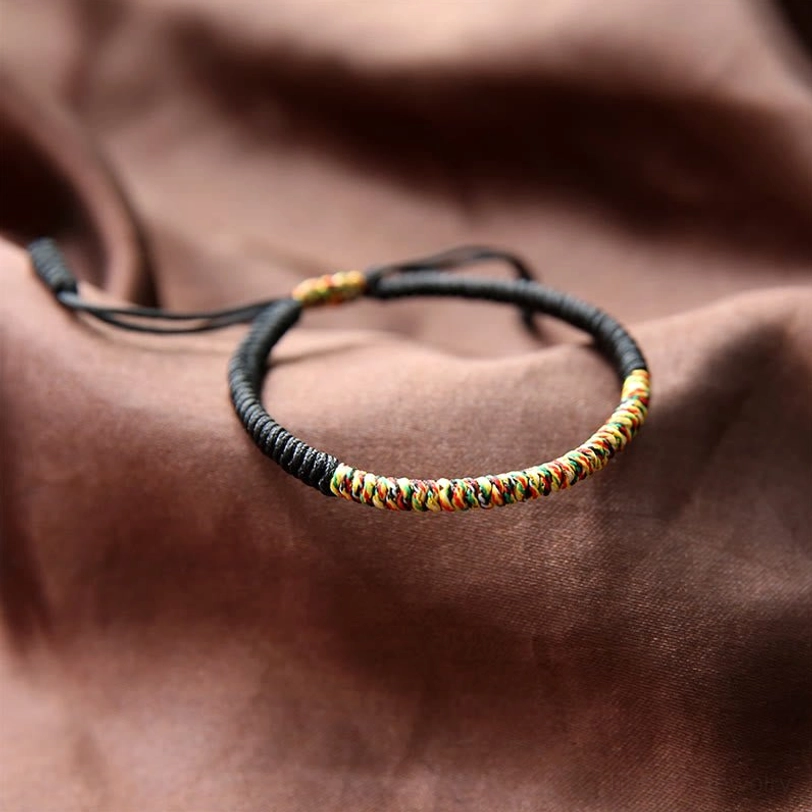 Black and multicolor Tibetan King Kong knot bracelet with protective evil-eye design, handwoven braided cord
