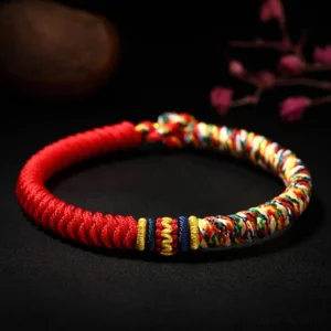 Tibetan King Kong Knot red multicolored braided bracelet overhead close-up view with handwoven details
