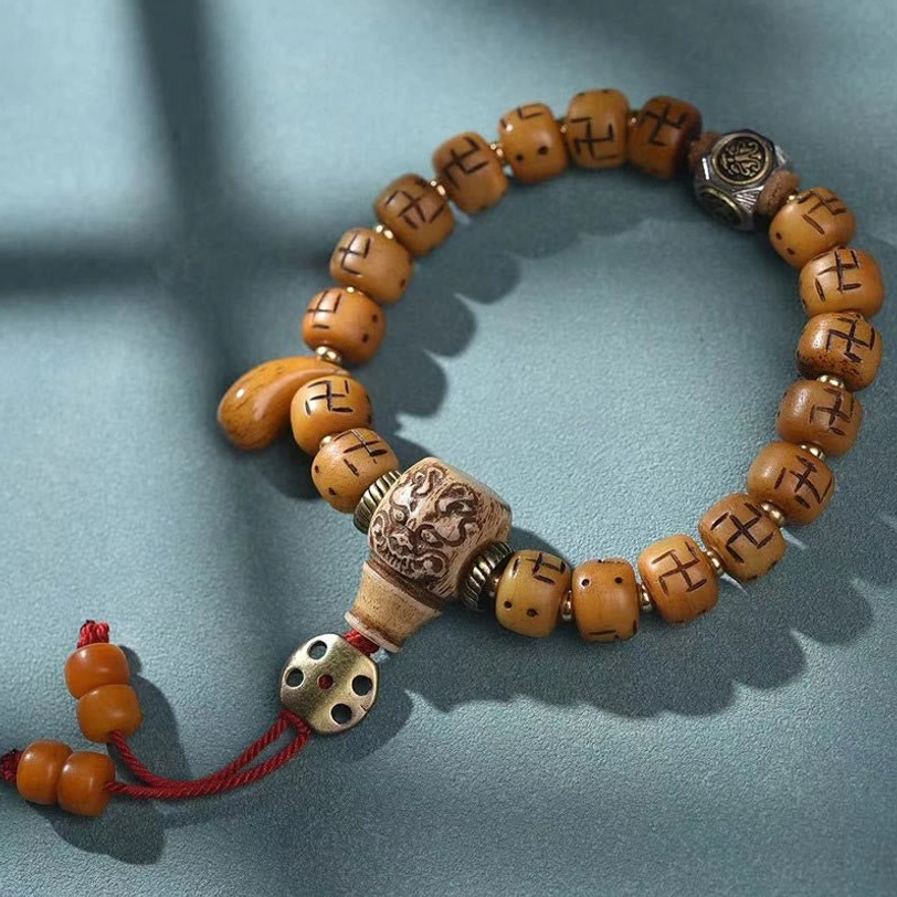 Tibetan Kirtimukha face protection bracelet with camel bone barrel beads - fierce protector guardian symbol for spiritual seekers