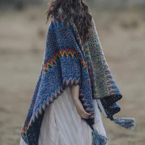 Back view of Tibetan knit cape featuring zigzag ethnic stitch pattern, draped fit with hanging tassels