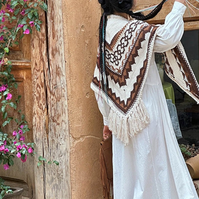Tibetan cultural knit shawl detail shot, brown beige stripes and traditional geometric motifs with tassel trim