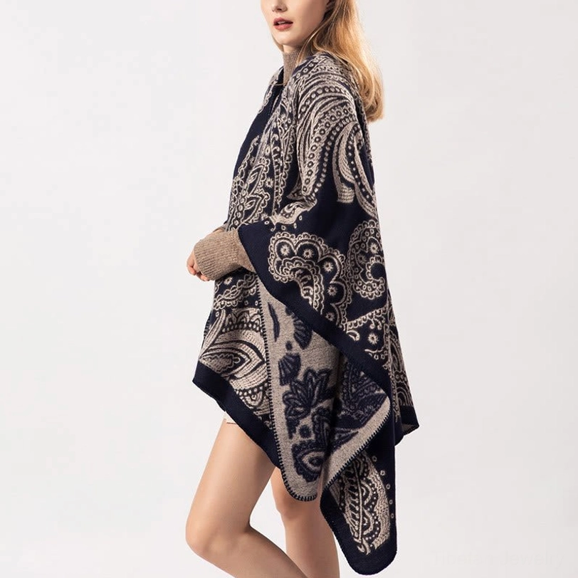 Tibetan paisley knit poncho, side three-quarter view highlighting soft fabric texture and navy taupe design