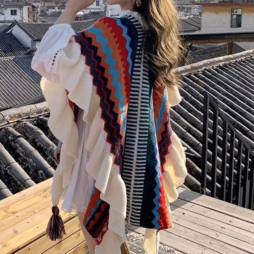 Tibetan knit shawl featuring blue and purple striped pattern with ruffled construction and decorative tassel accents
