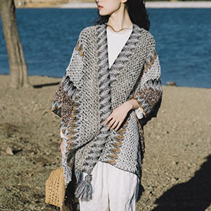Tibetan knit shawl with artisanal tassels showing close-up texture of mohair blend fabric quality