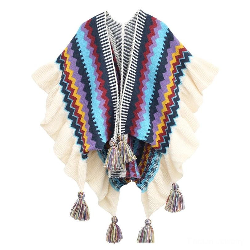 Colorful Tibetan knit shawl front display with zigzag stripes, ruffled cream hem and multi-color tassels