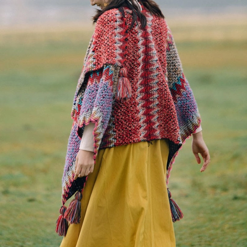 Knitted ethnic Tibetan wrap shawl with red and multi-color patchwork, multiple tassel trims, flowy fit back side view