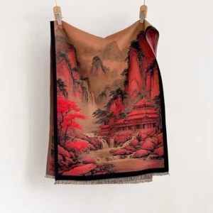 Full view of Tibetan landscape print scarf hanging flat against white backdrop, showing reversible red-brown mountain design with black trim and authentic fringe border