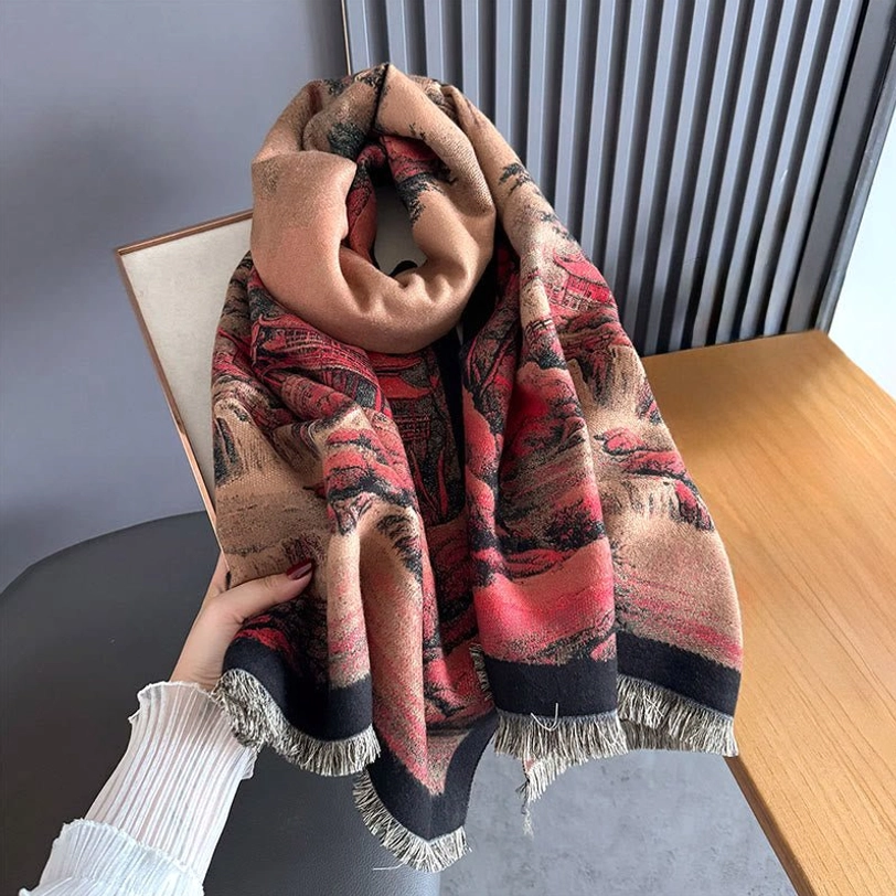 First-person perspective wearing Tibetan landscape scarf at home desk, demonstrating how the handwoven shawl drapes naturally with visible tassel fringe and double-sided pattern