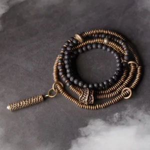 Tibetan lava rock brass multilayered healing bracelet flat lay top view dark studio background