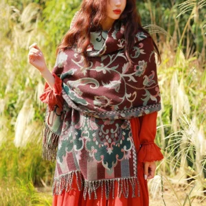 Tibetan vine leaf wrap scarf with reddish-brown jacquard design loose draped on model showing side profile
