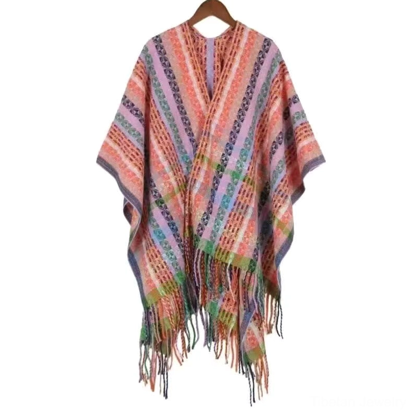 Tibetan boho tassel shawl in soft light pink tone featuring colorful geometric patterns and decorative fringe