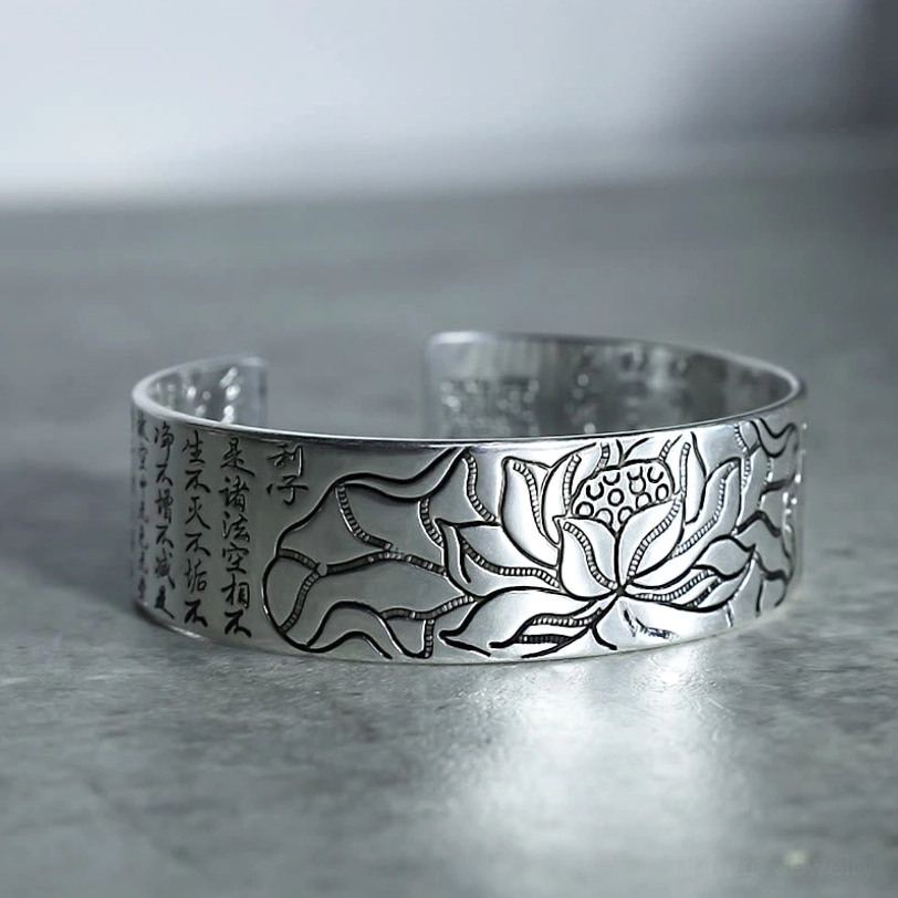 Tibetan lotus white copper bracelet right side profile view with polished silver finish, lotus and sutra engravings clearly visible