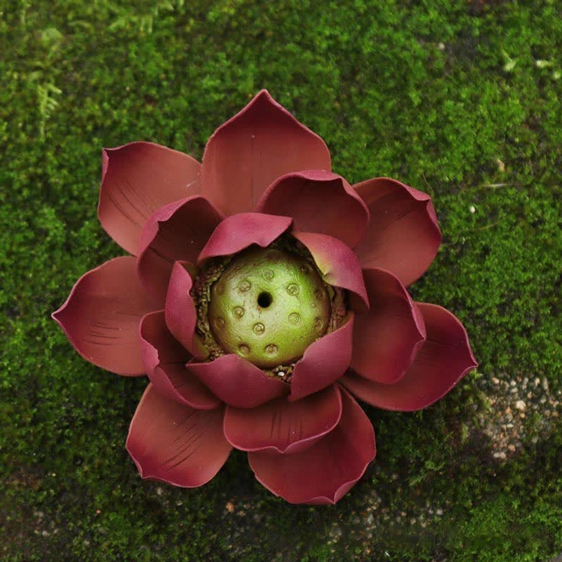 Open lotus incense burner overhead top-down view revealing reddish-brown clay with ornate green seed pod center chamber