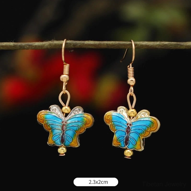 Lotus butterfly enamel earrings handmade detail showing individual artisan craftsmanship and color variations