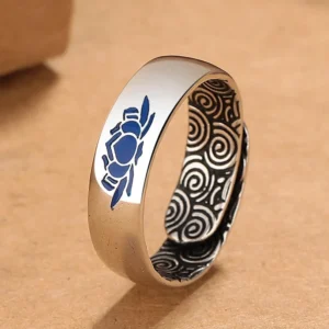 Tibetan blue lotus copper enlightenment ring with auspicious clouds engraving, left three-quarter view showing intricate enamel work