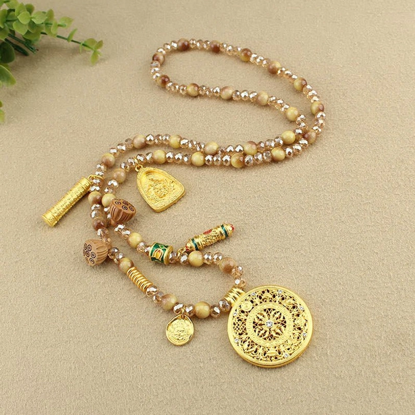 Complete Tibetan beaded necklace set with multiple gold charms and lotus pendant flat lay
