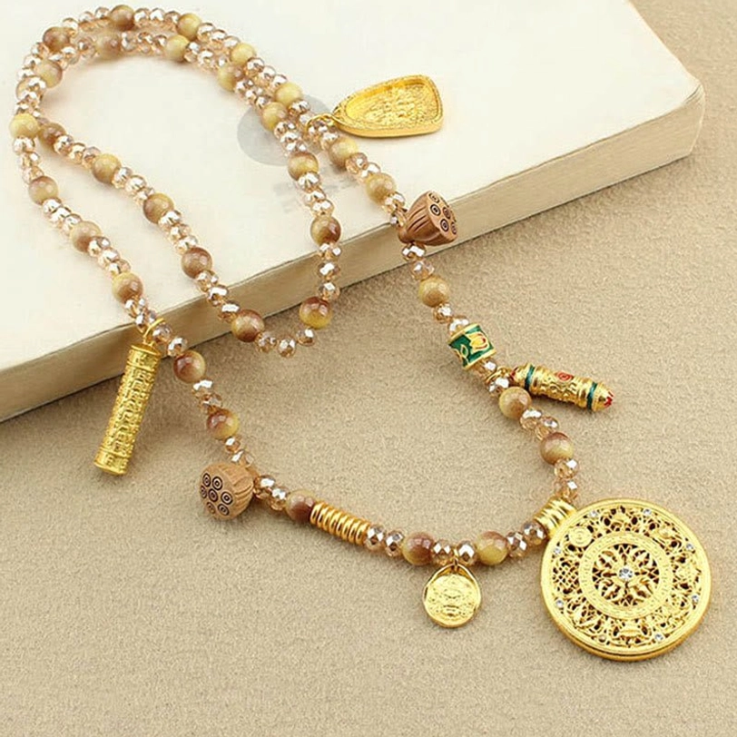 Full layout of Tibetan lotus necklace with carved gold round pendant and mixed beads