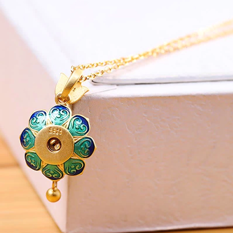 Tibetan lotus prayer wheel necklace with delicate gold chain and cloisonné pendant displayed in white gift box, complete product presentation