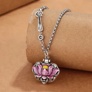 Pink enamel lotus pendant necklace with vintage copper chain, oblique view on kraft paper background