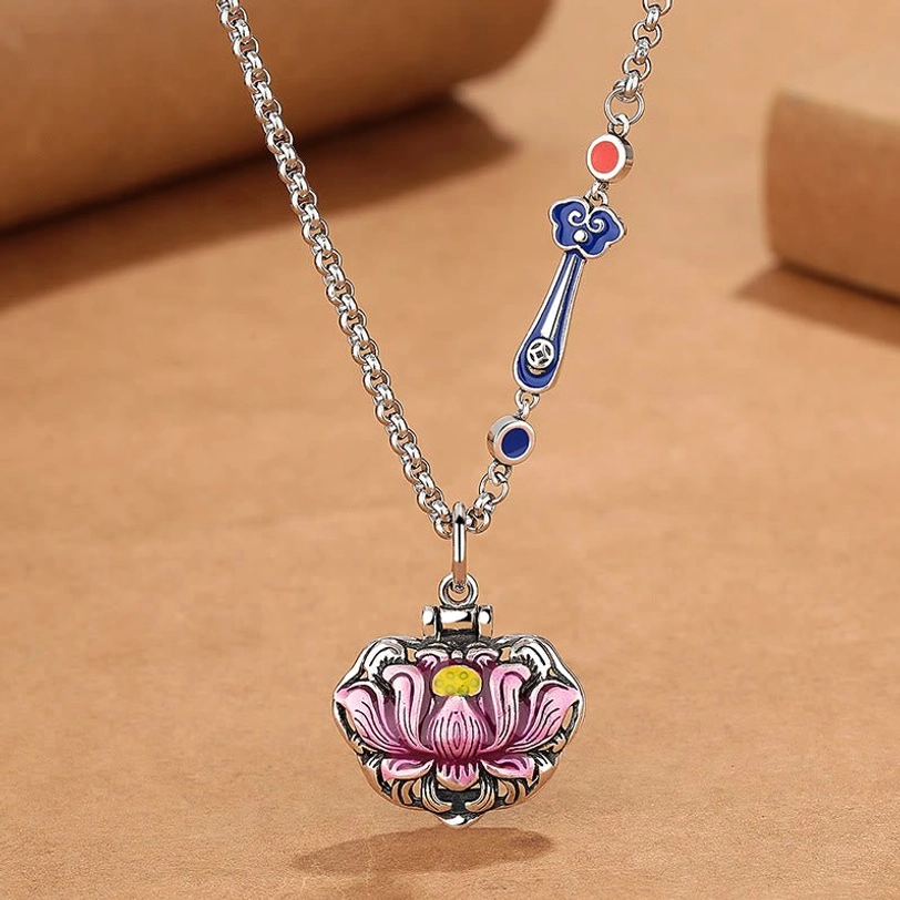 Blue and pink enamel lotus necklace flat lay showing detailed enamel work and cloud accents
