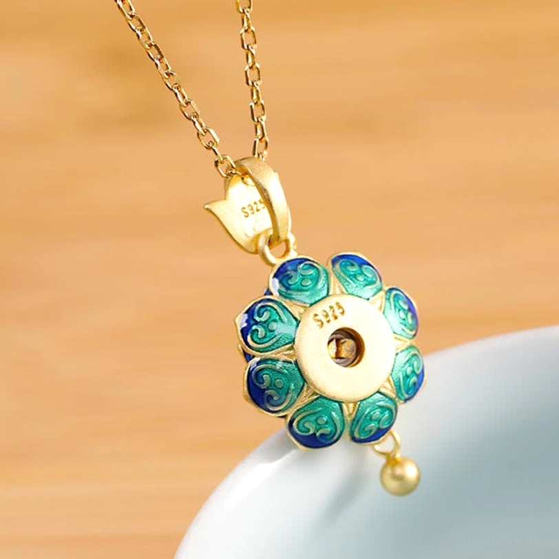 Reverse side of Tibetan lotus prayer wheel pendant showing cloisonné blue-green petals, 925 sterling silver hallmark stamp, and small gold dangle bead detail