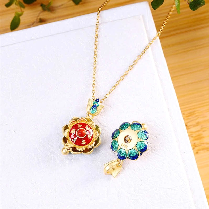 Tibetan lotus prayer wheel pendant necklace set showing detachable components with red enamel front and blue-green cloisonné reverse side, flat lay display