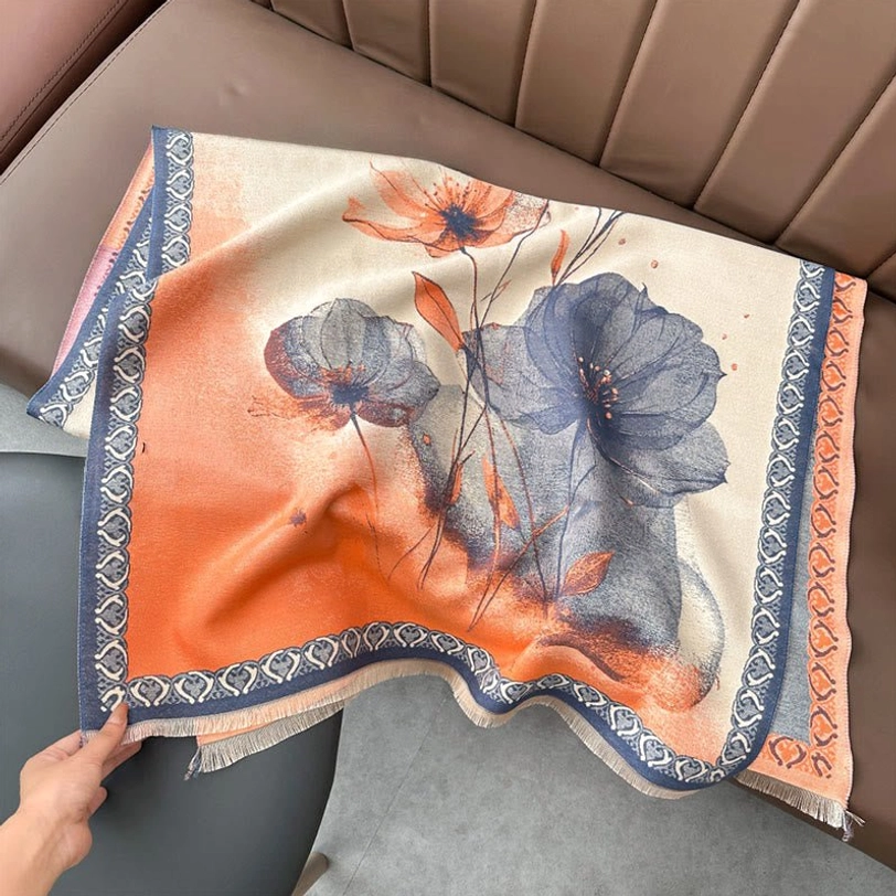 Light salmon tibetan lotus scarf with orange-blue gradient floral print and decorative woven trim flat lay