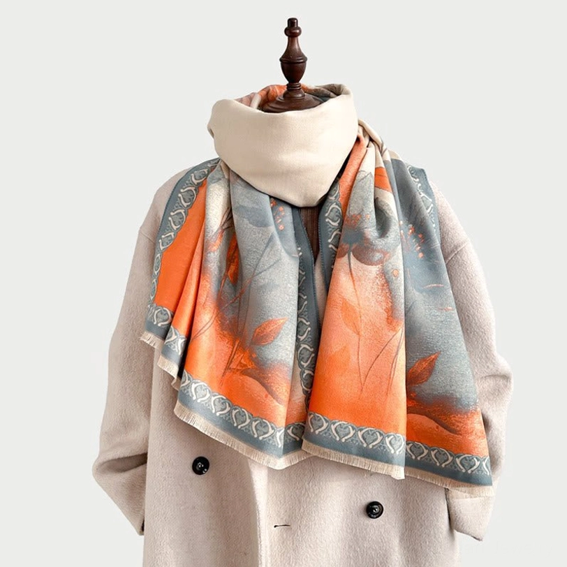 Lotus ink painting scarf worn as collar accent with coat showing orange-gray floral pattern and artisan detailing
