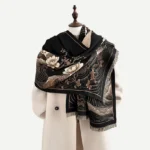Black Tibetan lotus ocean waves tassel shawl displayed on mannequin with golden floral motifs