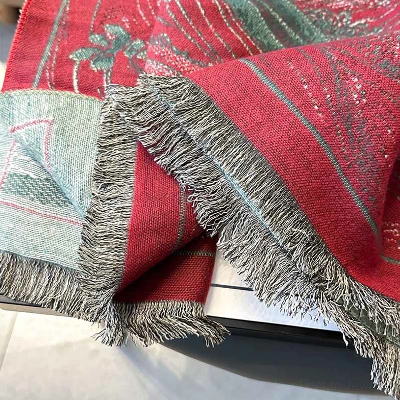 Fabric texture close-up of Tibetan shawl showing woven detail and gray fringed hem