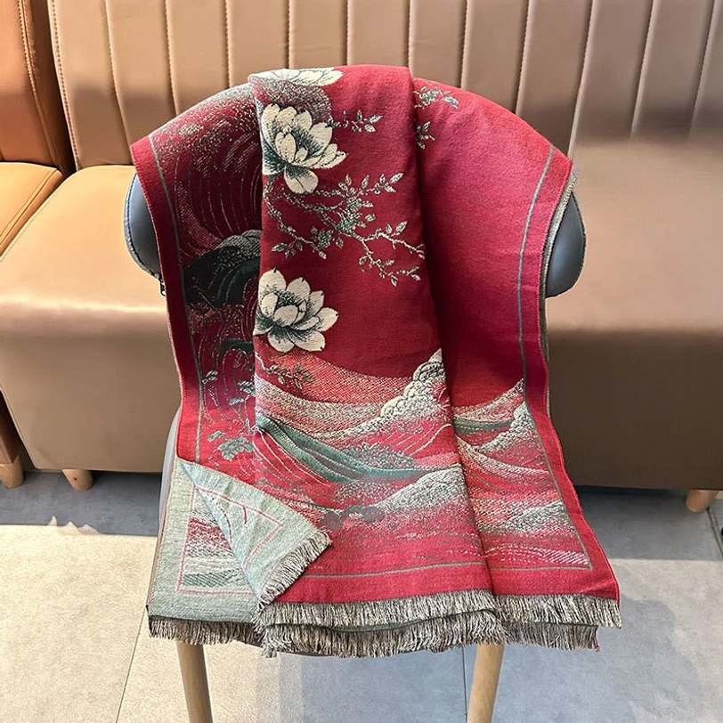 Overhead view of red Tibetan lotus tassel shawl draped on chair showing full pattern