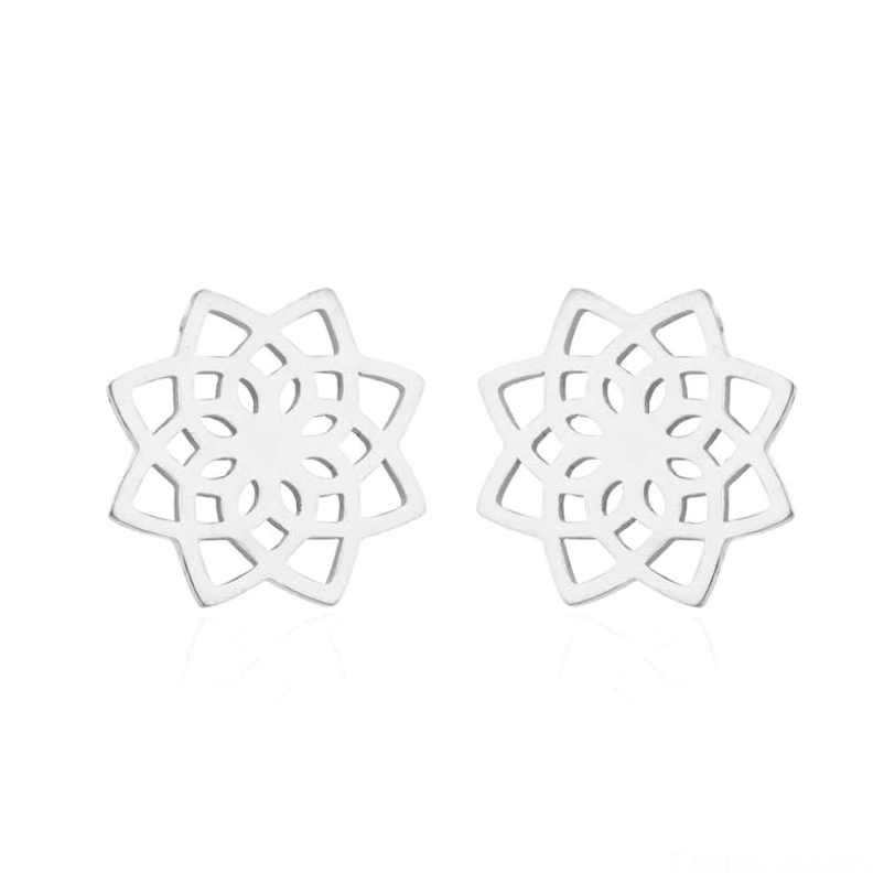 Pair of silver tibetan lotus pattern stud earrings flat lay studio display