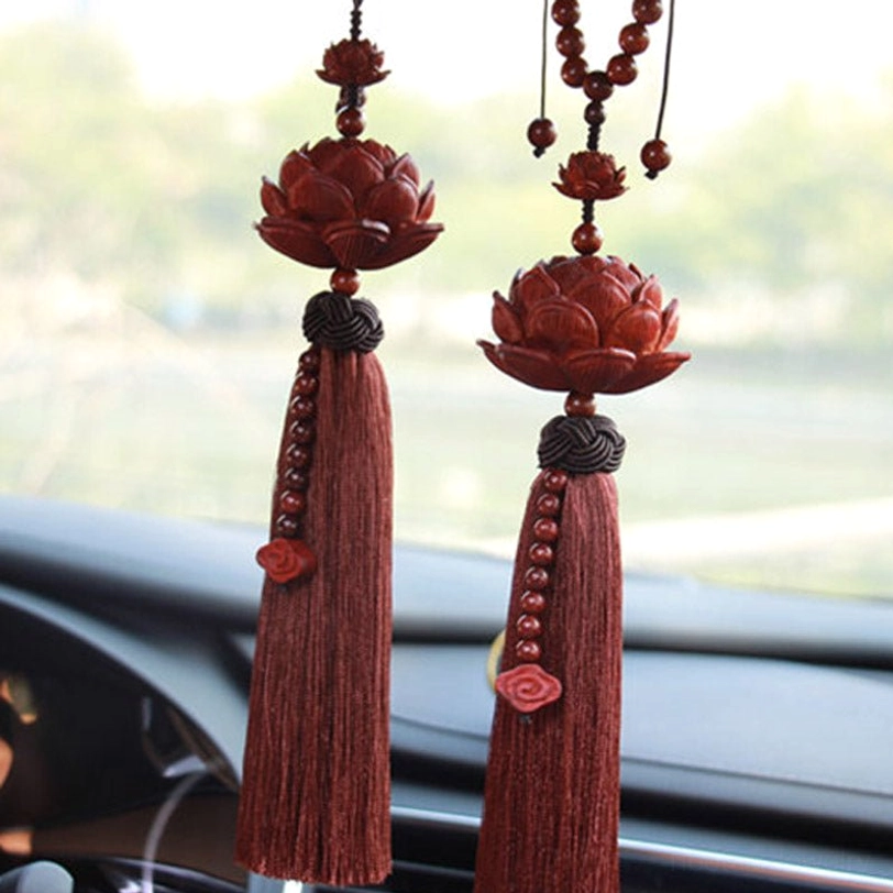 Pair of matching red sandalwood lotus tassel car hanging decorations in car interior showing dual cloud charms and beaded strands