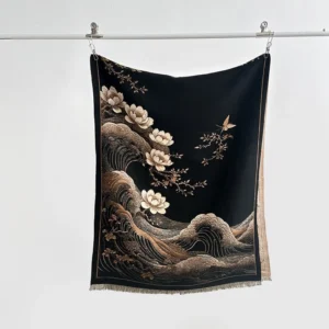 Black tassel shawl hanging display showing detailed lotus and wave print patterns with fringed edges