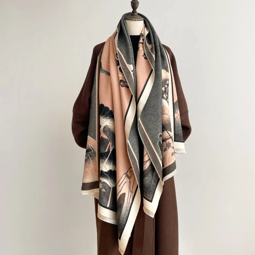 Handwoven Tibetan lotus shawl with color-blocked panels and ink wash motifs, front view on model with brown overcoat