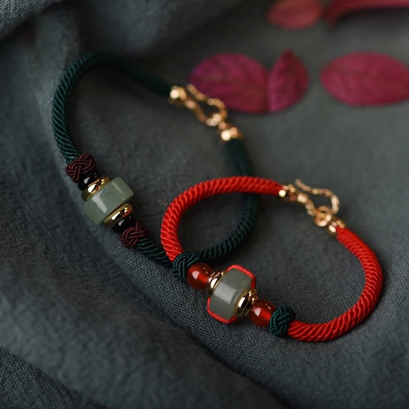 Tibetan green aventurine and red agate lucky braid bracelet flat lay featuring two colorways with jade barrel beads and gold-toned toggle clasps