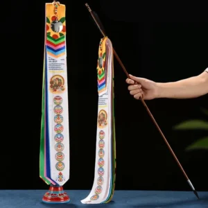 Tibetan Lucky Arrow prayer flag set with colorful silk ribbons, wooden pole and base on dark blue tabletop, front flat display view