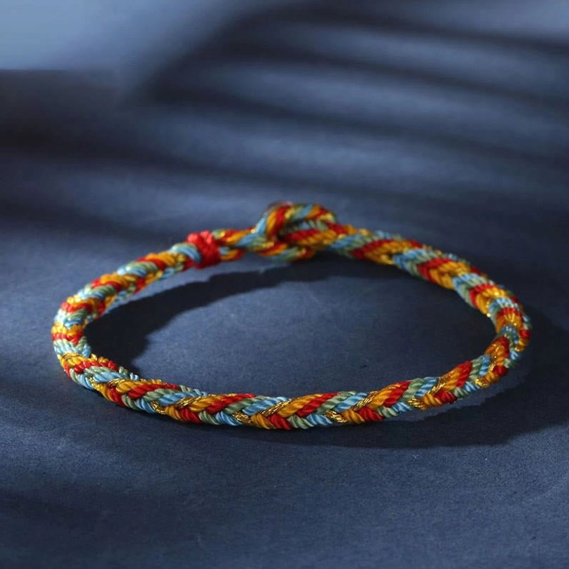 Tibetan multicolor protection bracelet with mixed thread colors displayed in circular form with soft studio lighting