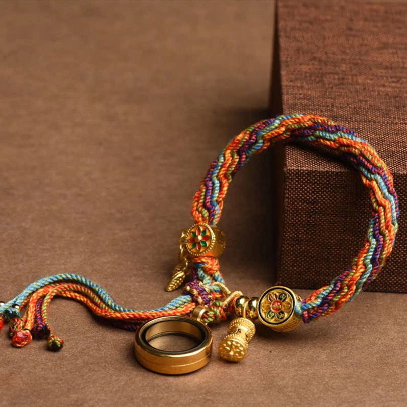 Handcrafted Tibetan woven bracelet with rainbow braided cord and gold enamel round charm