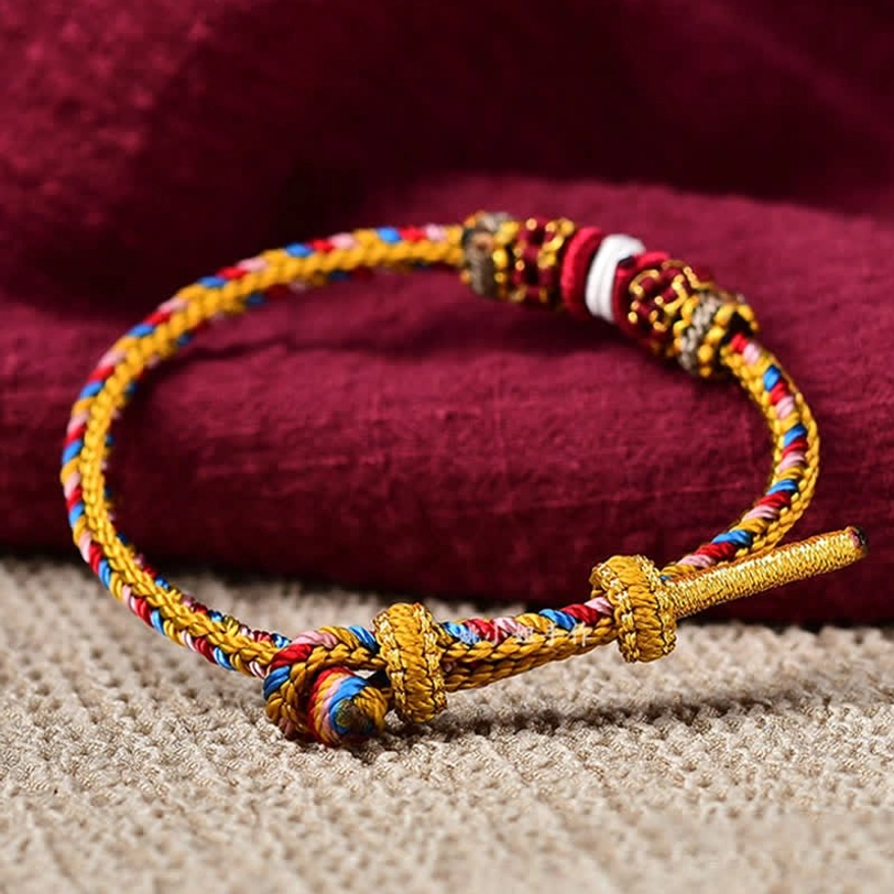 Adjustable Tibetan lucky bracelet with golden toggle clasp and elaborate woven knots
