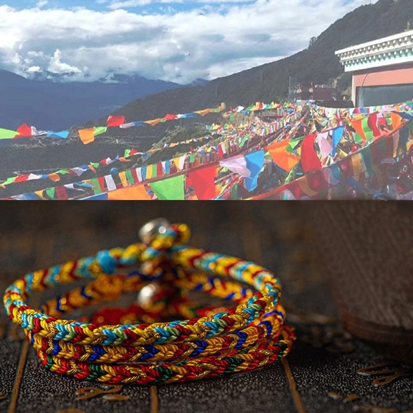 Tibetan lucky bracelets stacked display with prayer flags and mountain landscape background