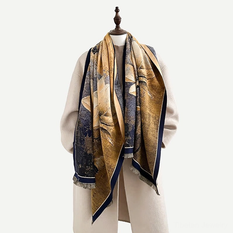 Mannequin displaying Tibetan magnolia scarf with navy and golden brown color scheme and floral fringe detail