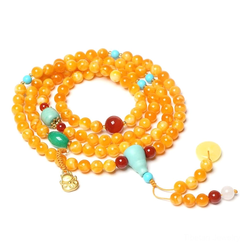 Classic 108-bead Tibetan mala necklace with turquoise red agate peace buckle and gold pendant on light background