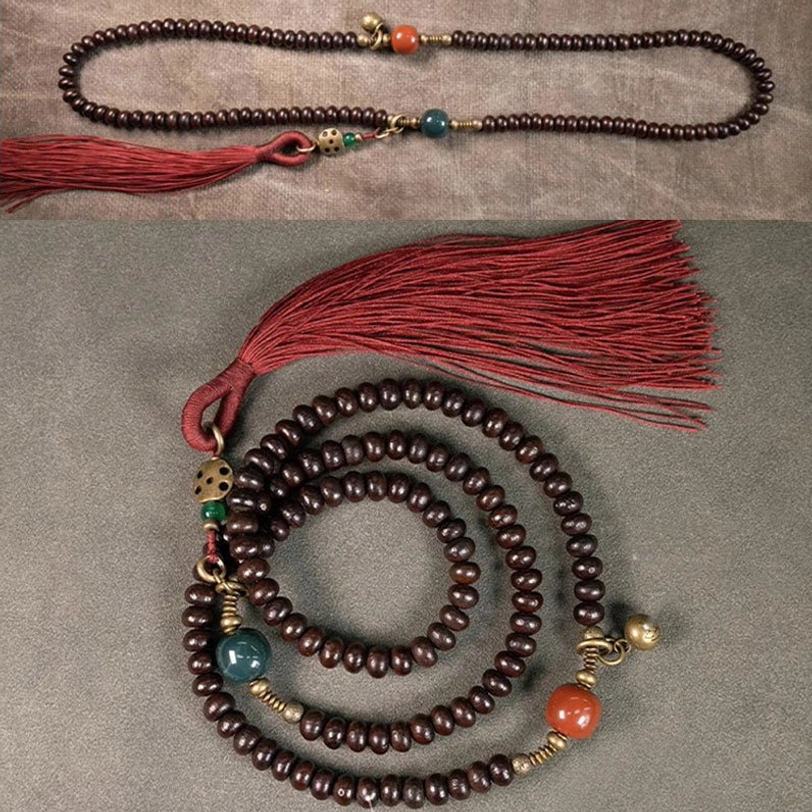 Tibetan 108-bead mala bracelet showing agate spacers and copper hardware detail
