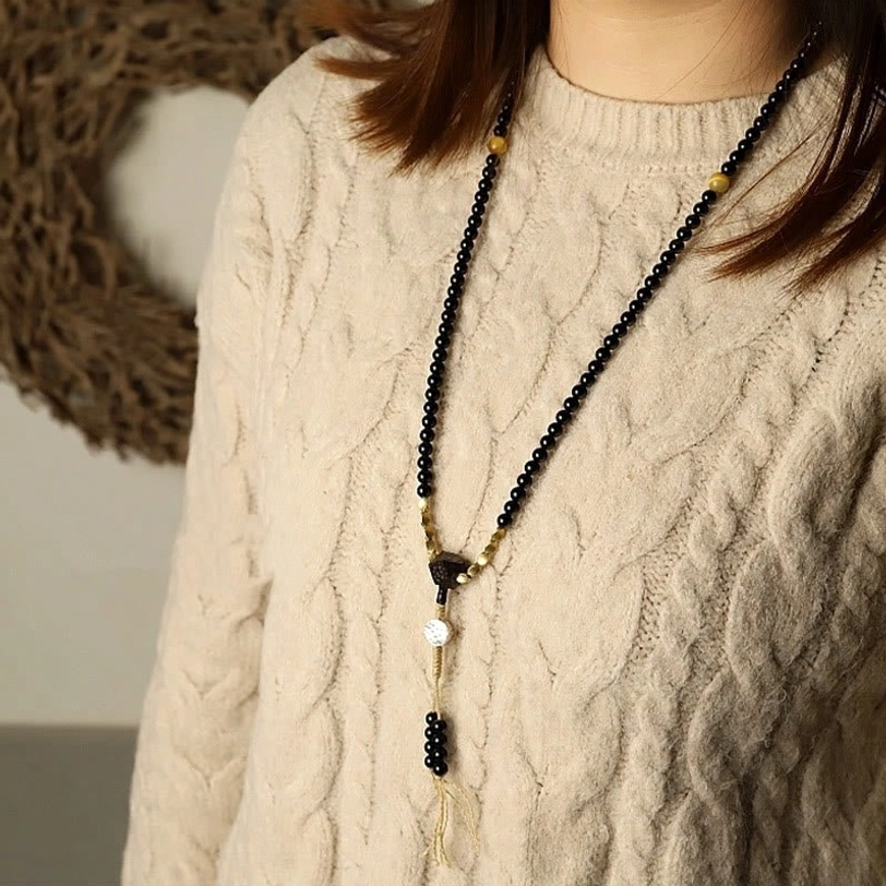 Black onyx and copper mala bracelet variant with traditional Tibetan dzi bead focal stone